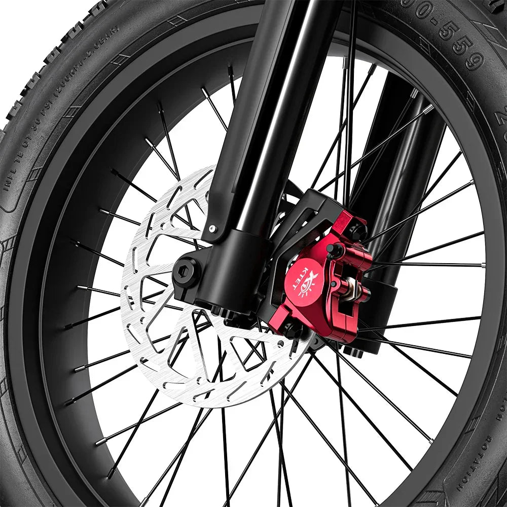 Close-up of a motorcycle wheel with disc brake and red caliper on a white background