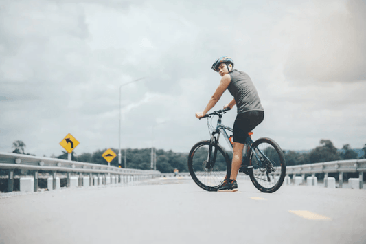 Person riding an electric bike on an open road, Pogo Cycles e-bike store lifestyle image