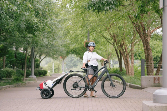 LIVOLT electric bike in matte black with rear trailer, side view in park setting