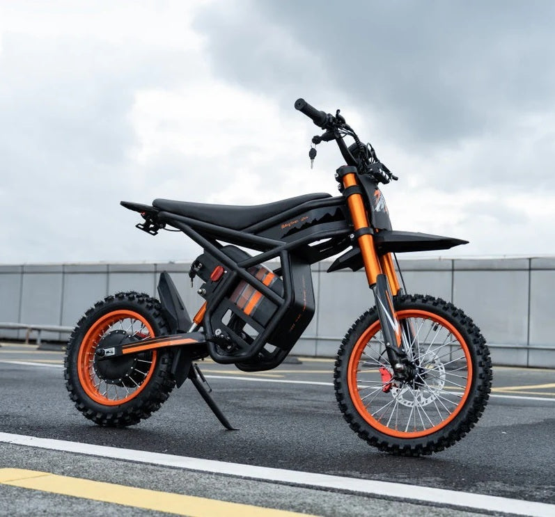 Riding Times GT54 Electric Bike on a road with a cloudy sky.