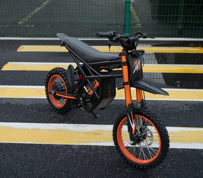 Riding Times GT54 Electric Bike in black and orange on a road with yellow lines