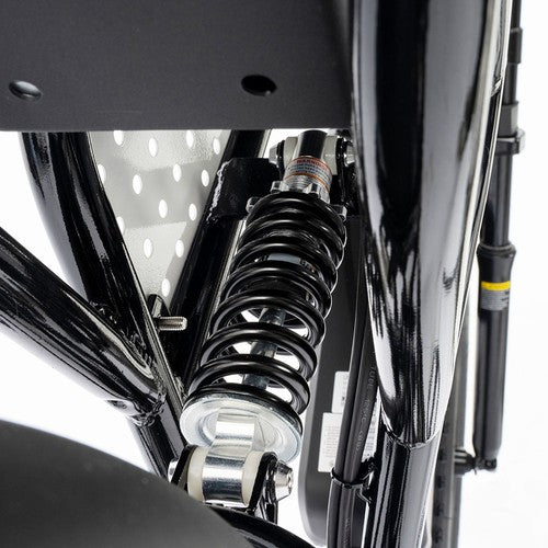 Close-up of a Ridstar Q20 Mini Electric motorcycle suspension system on a white background