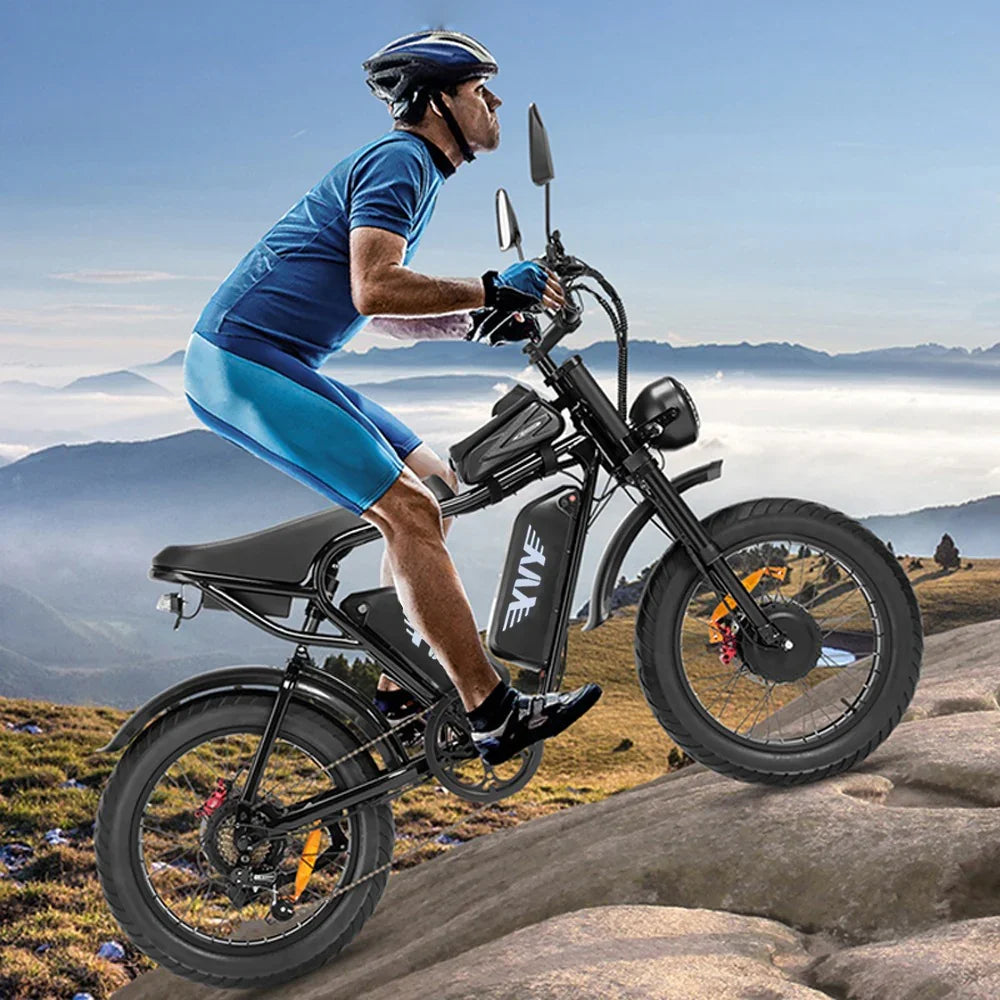 Person riding an YVY C20 Max Electric Bike on a mountainous landscape